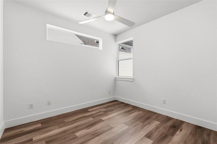 A versatile secondary bedroom with a ceiling fan and clean lines, ideal as a home office, guest room, or flex space that adapts as your needs change.