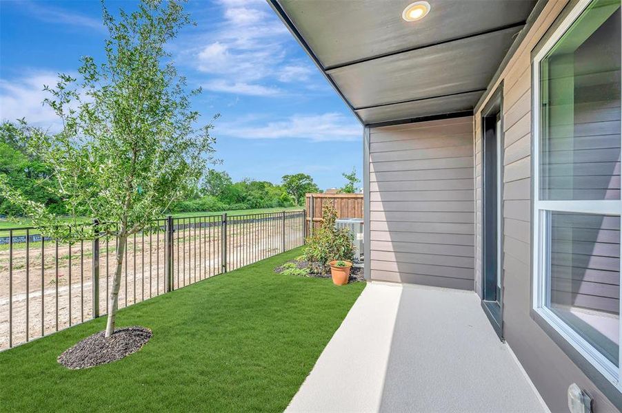 Covered patio featuring a recessed light fixture, a concrete slab, and an exterior wall with horizontal siding