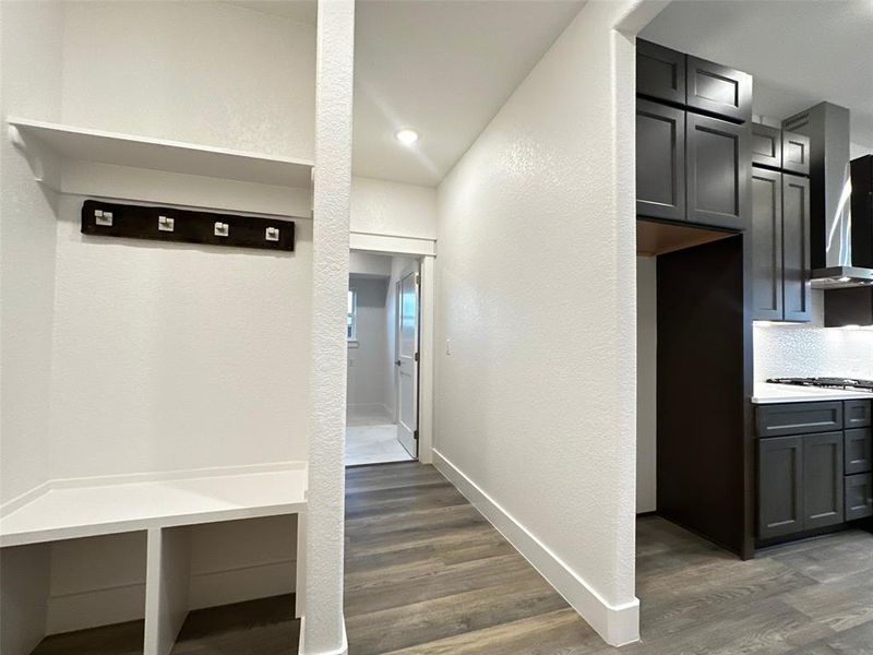 Mudroom featuring baseboards and dark wood-style flooring