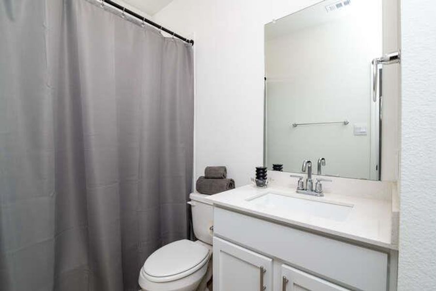 Full bathroom featuring vanity and a shower with shower curtain