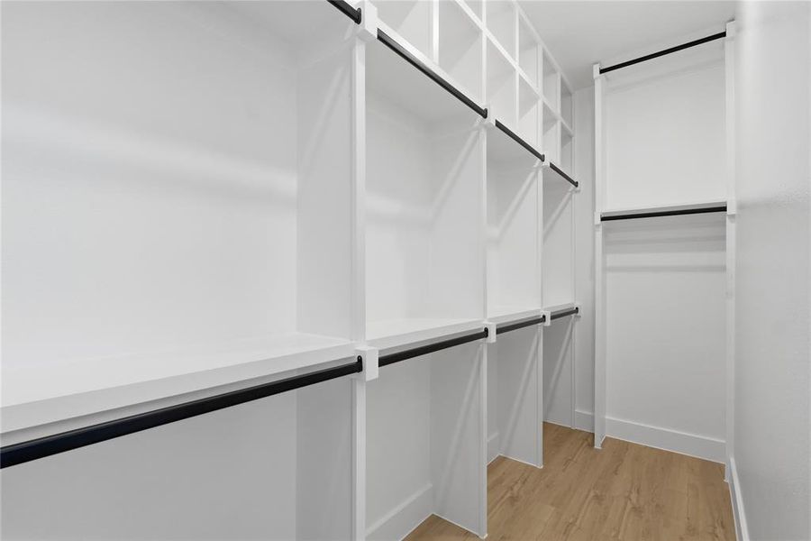 Walk in closet featuring light wood-style flooring