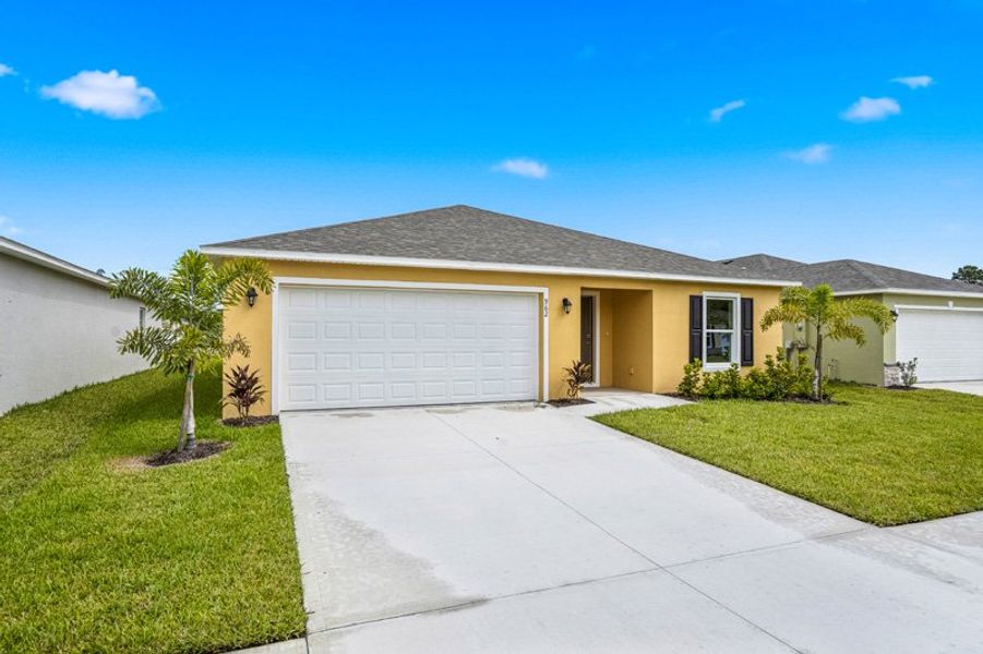 Front exterior of a new home in Richmond Cove, Palm Bay, FL, highlighting curb appeal (Image 21). Front exterior of a new home in Richmond Cove, Palm Bay, FL, highlighting curb appeal (Image 21).