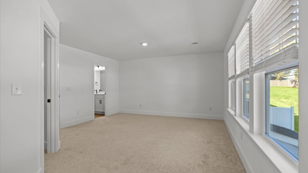 Exclusive upstairs retreat with a bright and airy primary suite with a walk-in closet