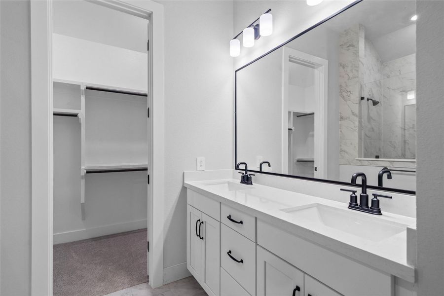 An alternative perspective highlights the luxury double-sink vanity, where custom cabinetry beautifully contrasts with premium matte black hardware details. An alternative perspective highlights the luxury double-sink vanity, where custom cabinetry beautifully contrasts with premium matte black hardware details.