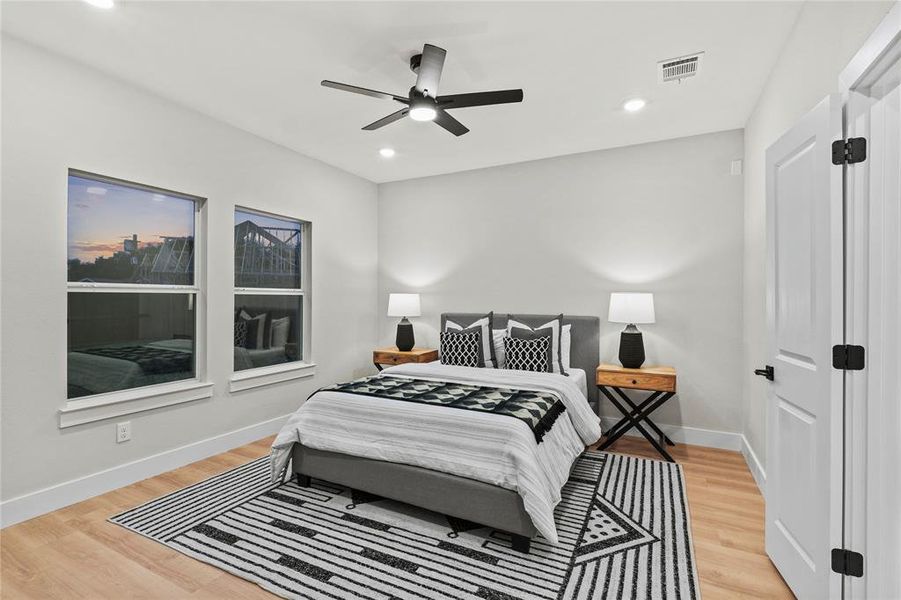 Bedroom featuring ceiling fan and hardwood / wood-style floors