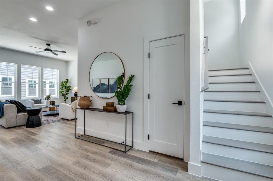 Staircase featuring recessed lighting, ceiling fan, and wood finished floors