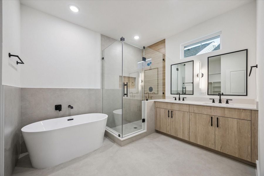 Spa-inspired primary bath with soaking tub and glass shower Spa-inspired primary bath with soaking tub and glass shower