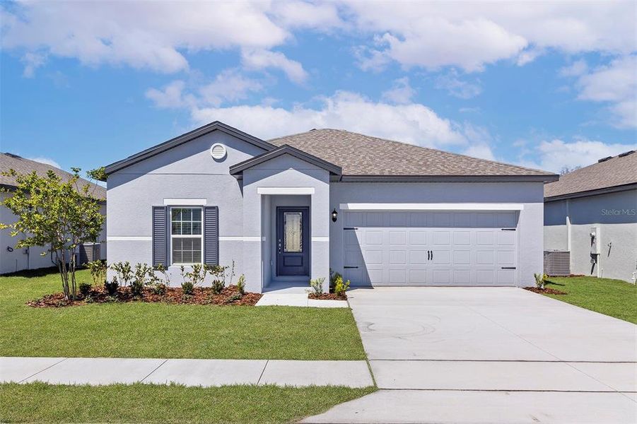 Front exterior of a new home in Peach Crossings, Winter Haven, FL, highlighting curb appeal (Image 2). Front exterior of a new home in Peach Crossings, Winter Haven, FL, highlighting curb appeal (Image 2).