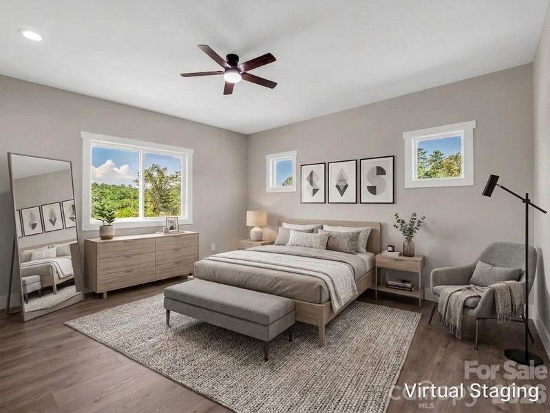 Primary suite filled with abundant light, hardwood floors, insulated windowsVirtually Staged to allow buyers to envision the space Primary suite filled with abundant light, hardwood floors, insulated windowsVirtually Staged to allow buyers to envision the space