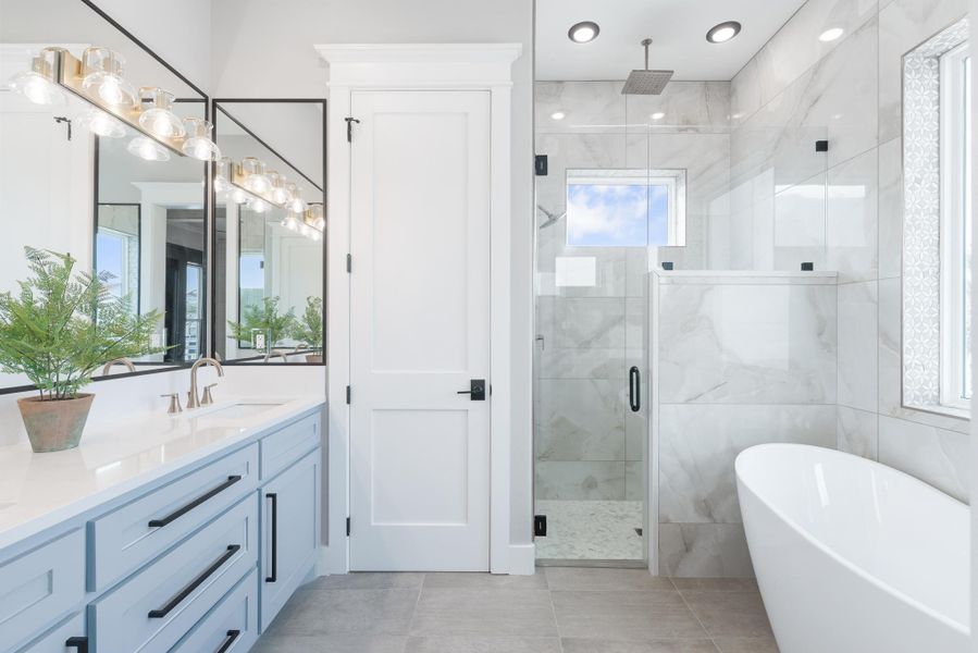 Bathroom featuring vanity, a soaking tub, a shower stall, and tile patterned flooring Bathroom featuring vanity, a soaking tub, a shower stall, and tile patterned flooring
