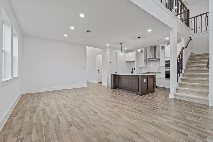 Unfurnished living room with light wood-type flooring and sink