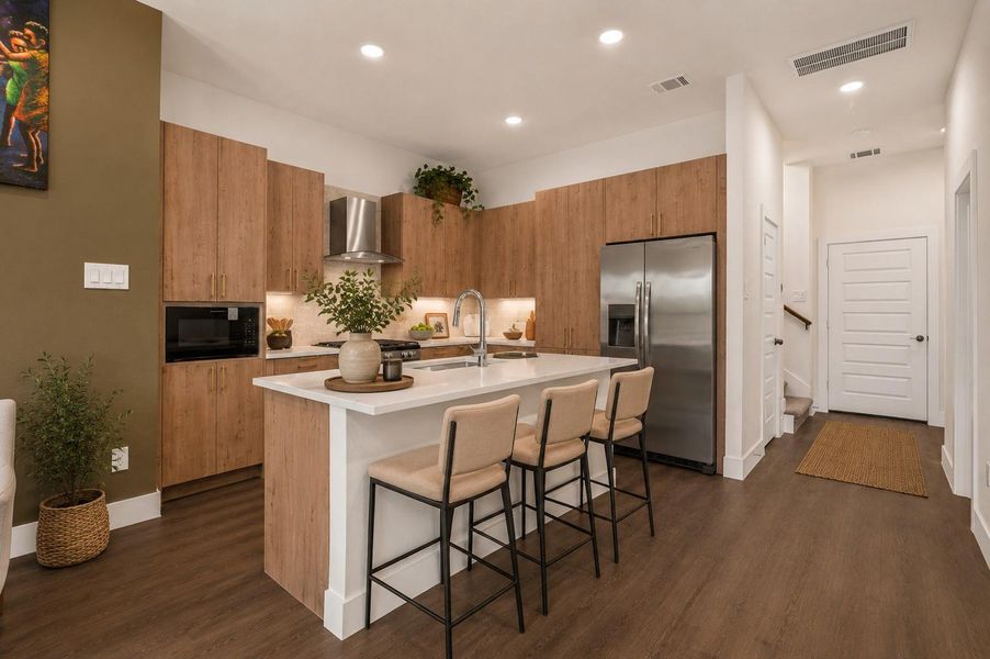 Contemporary island kitchen featuring quartz countertops, stainless steel appliances, soft-close cabinetry, and modern designer finishes throughout.