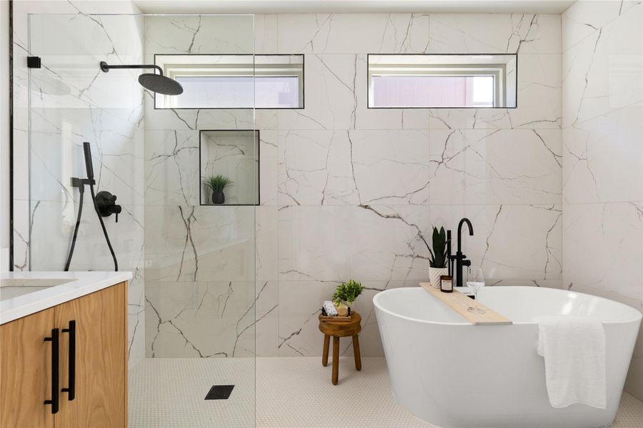 Floor-to-ceiling marble-patterned tile walling creates a spa-like atmosphere around the freestanding tub and glass shower.