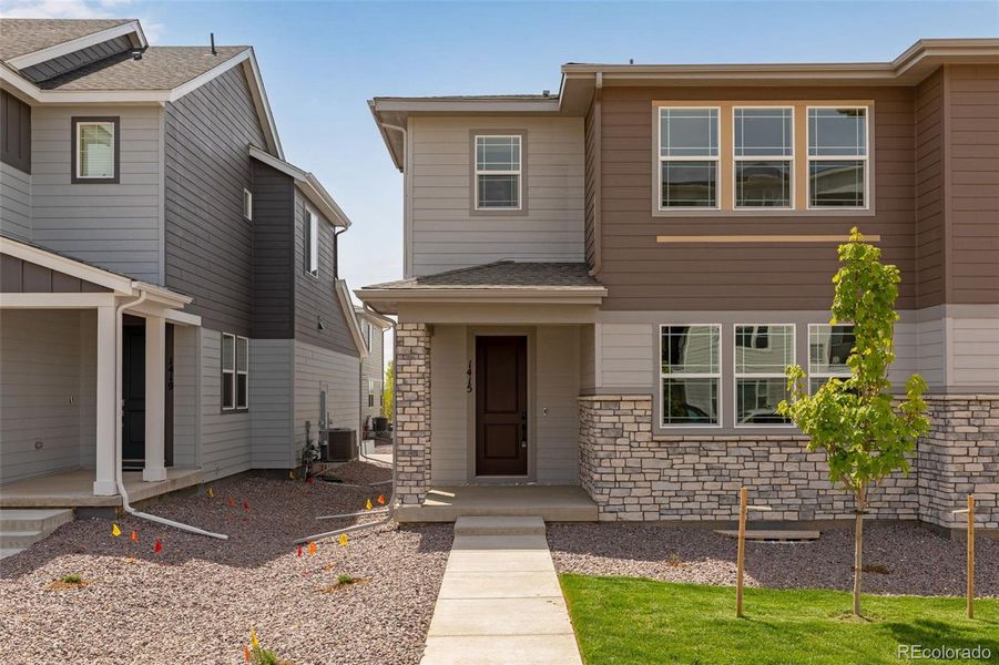 Front exterior of a new home in Sugar Mill Village, Longmont, CO, highlighting curb appeal (Image 1). Front exterior of a new home in Sugar Mill Village, Longmont, CO, highlighting curb appeal (Image 1).