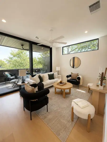 A well-lit secondary living area faces the private terrace and offers comfort with large windows and durable hardwood flooring. A well-lit secondary living area faces the private terrace and offers comfort with large windows and durable hardwood flooring.