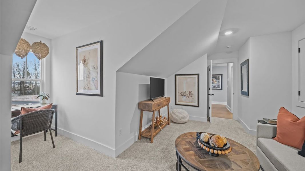 Vibrant loft with carpeted flooring and flexible space for work, play, or relaxing