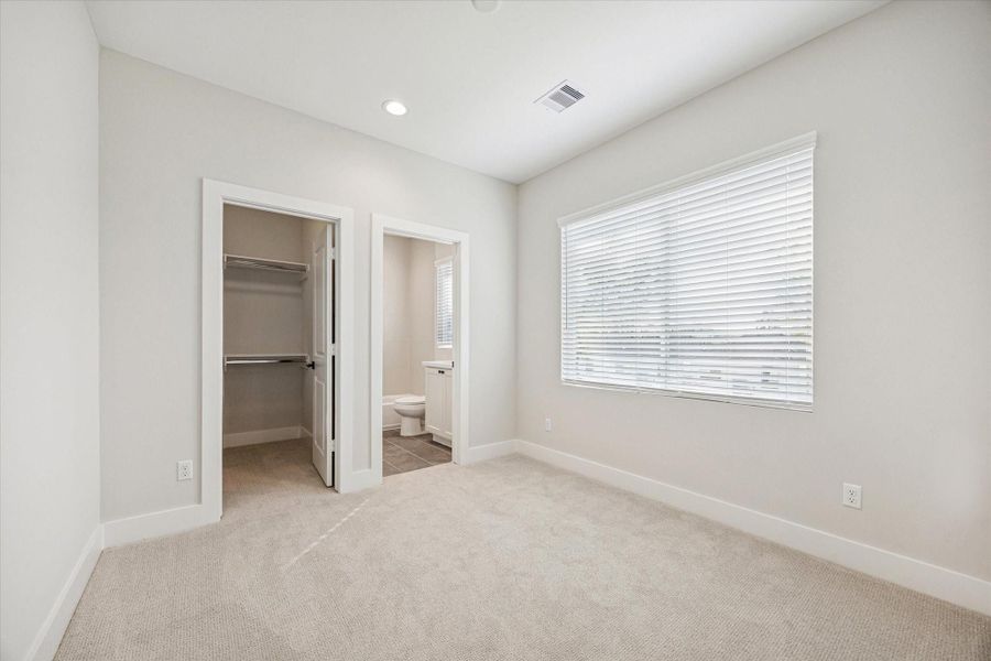Second bedroom on the third floor features recessed lighting, large windows, an ensuite bathroom and a walk-in closet.