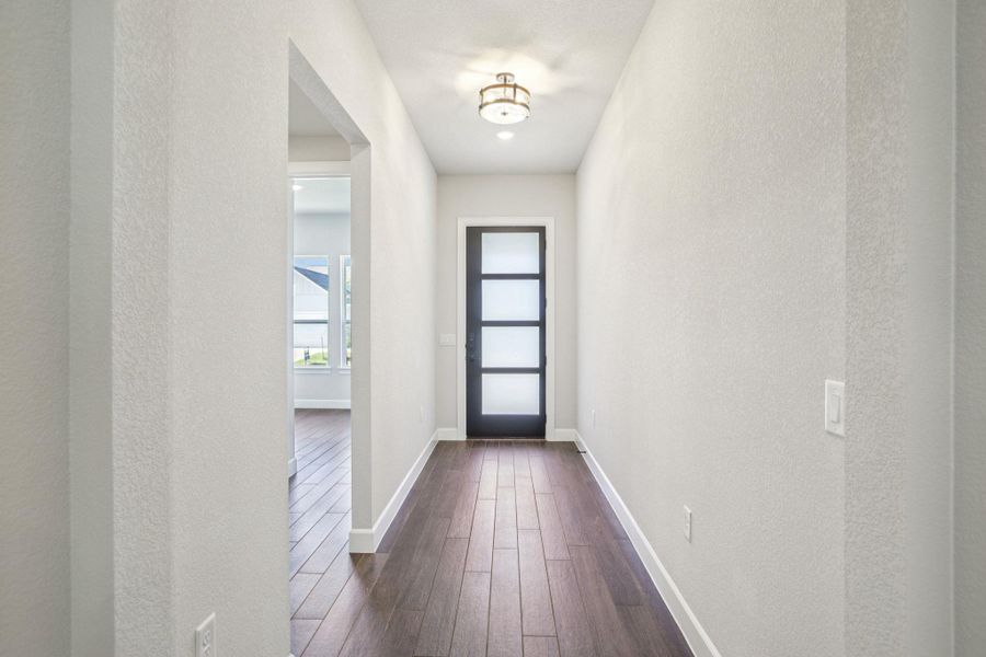 Entryway featuring a textured wall and wood finished floors