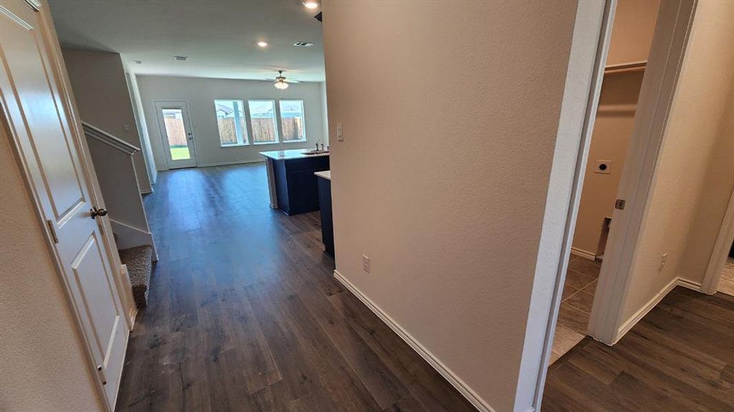 Open-concept living area featuring wood-finish flooring, a contemporary ceiling fan, and recessed lighting Open-concept living area featuring wood-finish flooring, a contemporary ceiling fan, and recessed lighting