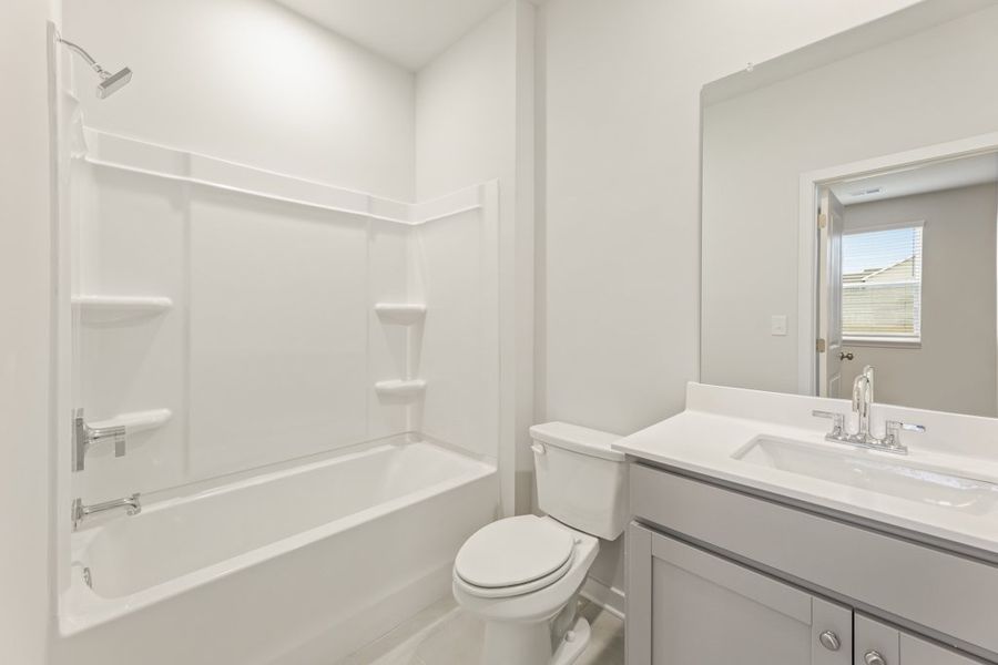 A bathroom with a tub toilet and sink. A bathroom with a tub toilet and sink.