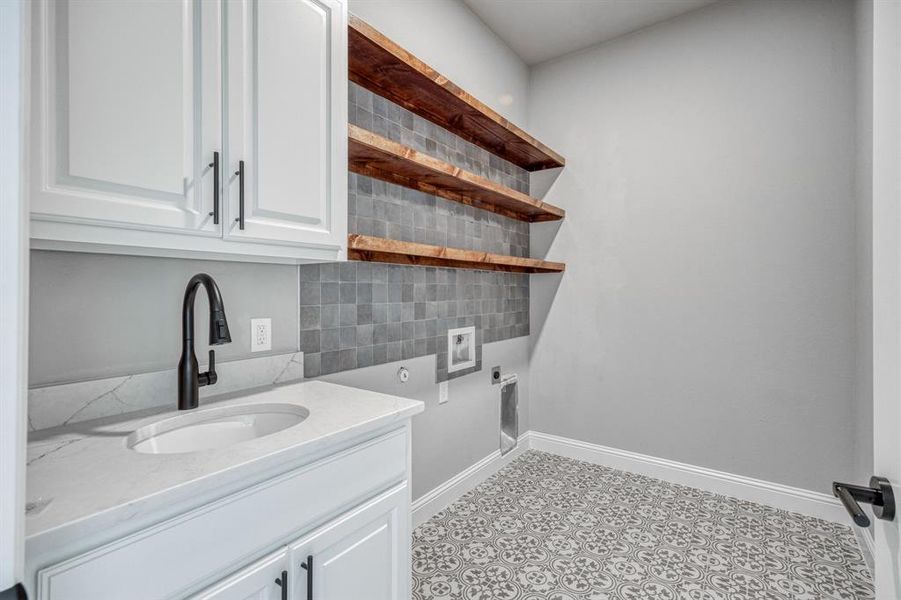 Handy counter space in a dedicated utility room with plenty of cabinet storage.