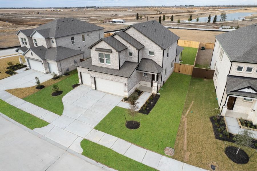 Front exterior of a new home in Creekhaven, Iowa Colony, TX, highlighting curb appeal (Image 2). Front exterior of a new home in Creekhaven, Iowa Colony, TX, highlighting curb appeal (Image 2).
