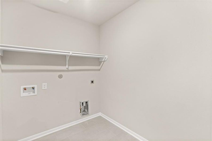 The laundry room layout is carefully planned for optimal workflow with designated areas for washing, drying, and storing.