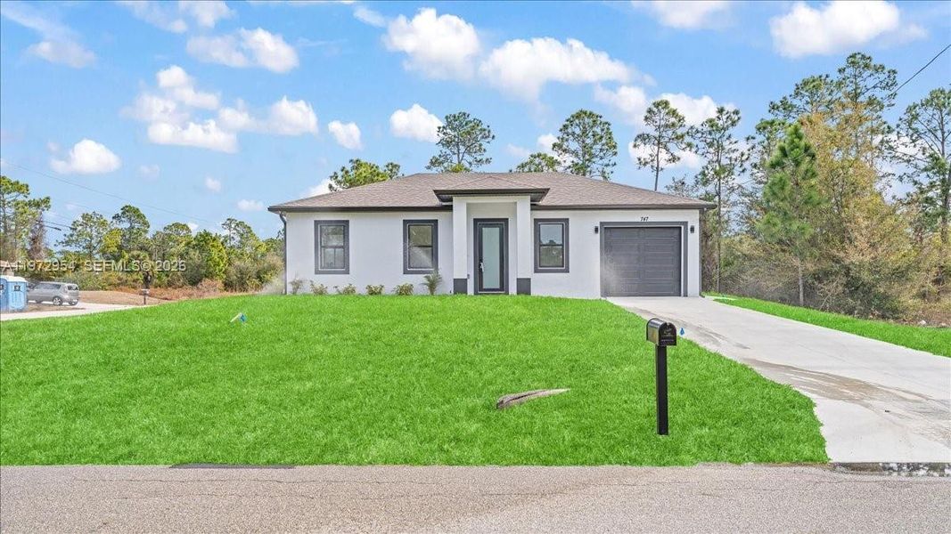 Front exterior of a new home in , Lehigh Acres, FL, highlighting curb appeal (Image 20).