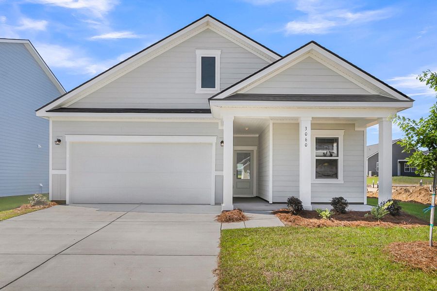 Front exterior of a new home in Tea Farm, Ravenel, SC, highlighting curb appeal (Image 19).