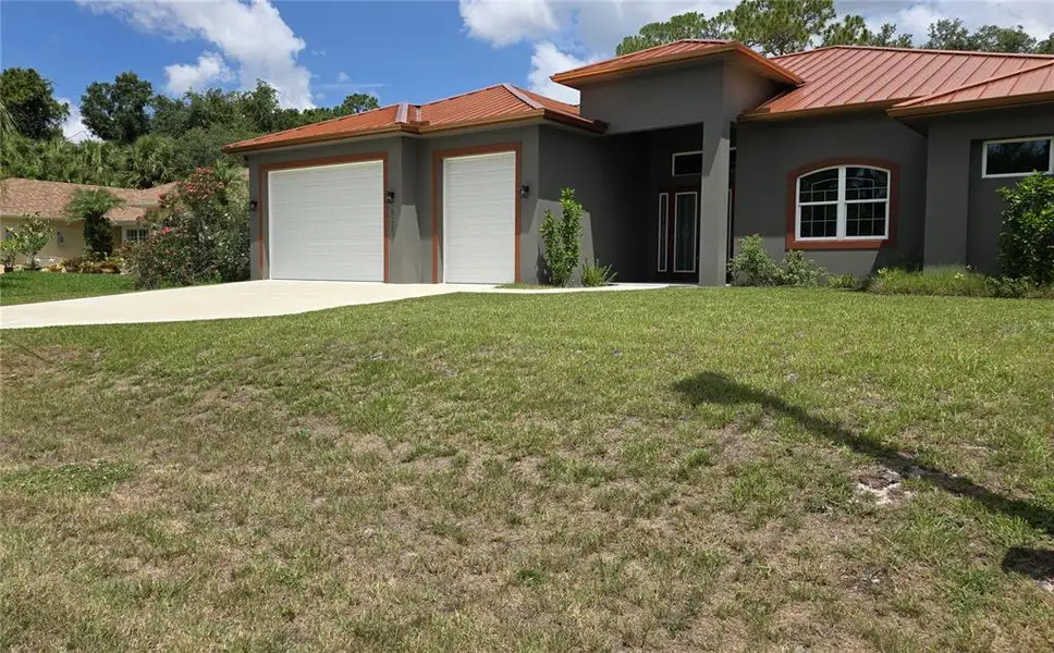 Front exterior of a new home in , North Port, FL, highlighting curb appeal (Image 2). Front exterior of a new home in , North Port, FL, highlighting curb appeal (Image 2).