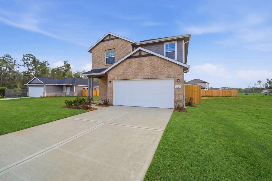 Front exterior of a new home in Caney Mills, Conroe, TX, highlighting curb appeal (Image 2).
