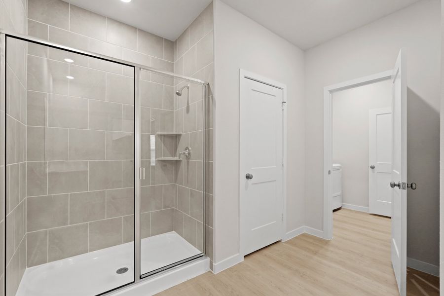 A bathroom with a glass shower. A bathroom with a glass shower.