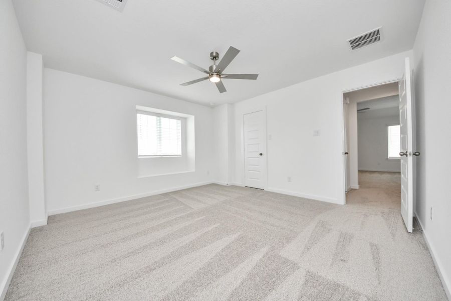 Generously sized secondary bedrooms featuring spacious closets, soft and inviting carpeting underfoot, large windows allowing plenty of natural light, and the added touch of privacy blinds for your personal retreat. Sample photo of completed home with similar floor plan. Actual colors and selections may vary.