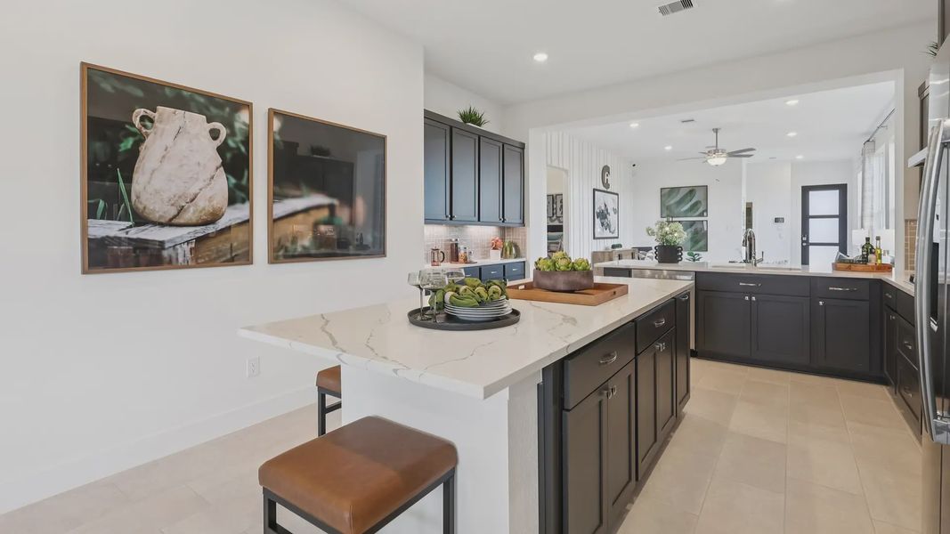 Representative furnished interior of a home built from the Adele by Chesmar Homes in Sunterra, Katy (Image 12).