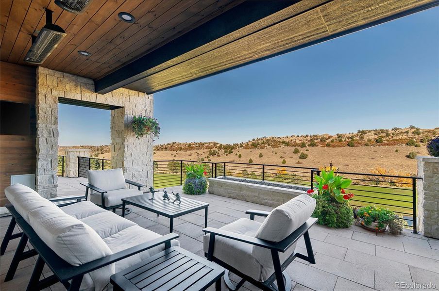 Tongue-and-groove ceilings, flagstone-accented walls, a sleek modern firepit, and built-in grill and smoker define this as an entertainer’s haven where sunrise coffees and twilight gatherings share the same breathtaking backdrop.