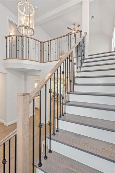 Wood Stairway featuring vaulted ceiling to second floor