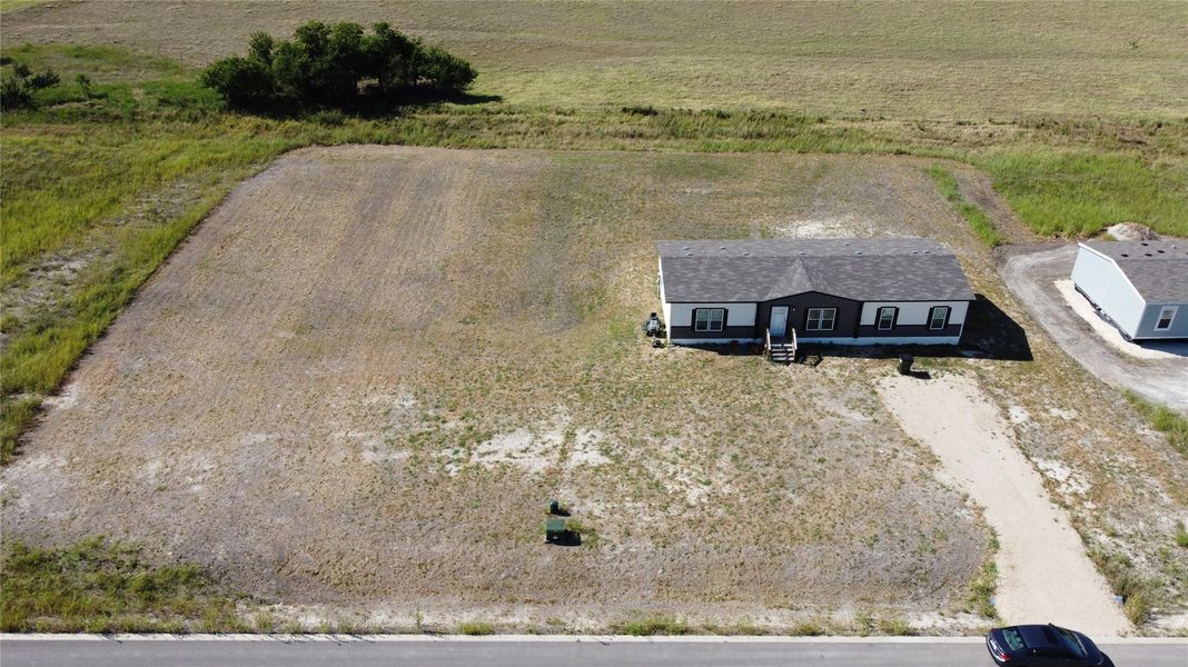 Discover a tranquil countryside retreat, offering a spacious lot and an inviting single-story residence with a gravel driveway. Discover a tranquil countryside retreat, offering a spacious lot and an inviting single-story residence with a gravel driveway.