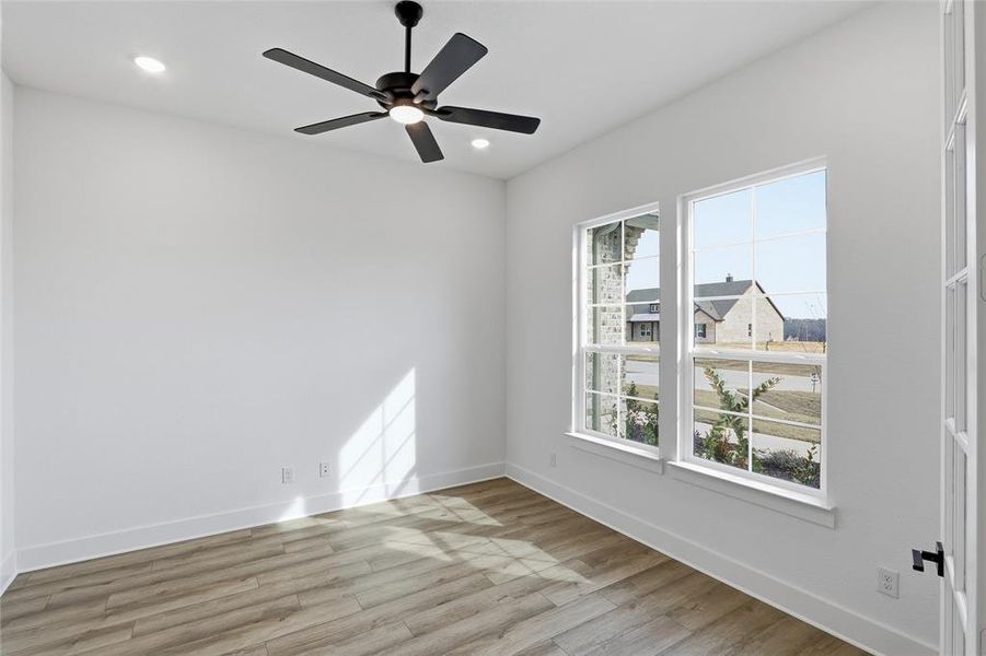 Empty room with light wood-style floors, ceiling fan, and recessed lighting