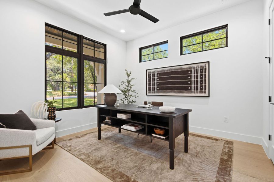 Clean lines and warm wood floors define this light-filled home workspace.
