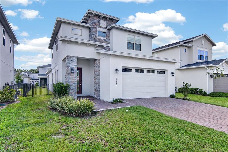 Front exterior of a new home in Twin Lakes, St. Cloud, FL, highlighting curb appeal (Image 2). Front exterior of a new home in Twin Lakes, St. Cloud, FL, highlighting curb appeal (Image 2).