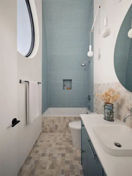 Bathroom with tiled shower / bath combo, vanity, and tile walls Bathroom with tiled shower / bath combo, vanity, and tile walls