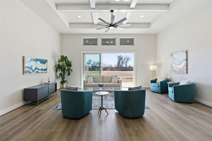 Living area featuring coffered ceiling, ceiling fan, and wood finished floors