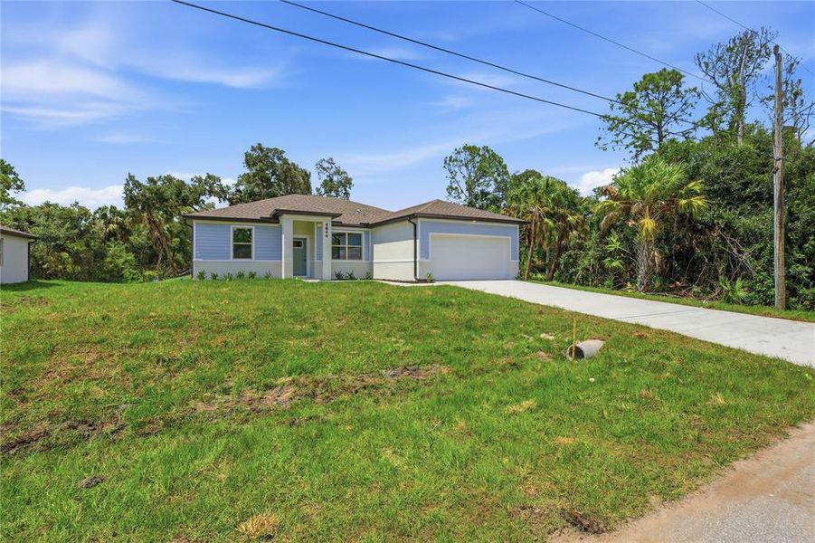 Front exterior of a new home in , North Port, FL, highlighting curb appeal (Image 21). Front exterior of a new home in , North Port, FL, highlighting curb appeal (Image 21).