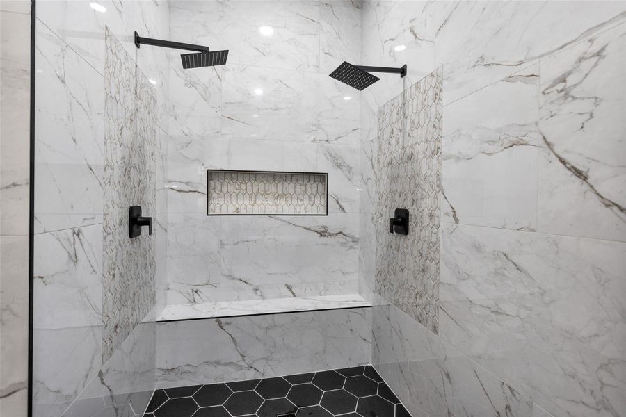 Welcome to your primary shower. Notice the multiple shower heads, bench seating, accessories cove and art tile work. Welcome to your primary shower. Notice the multiple shower heads, bench seating, accessories cove and art tile work.