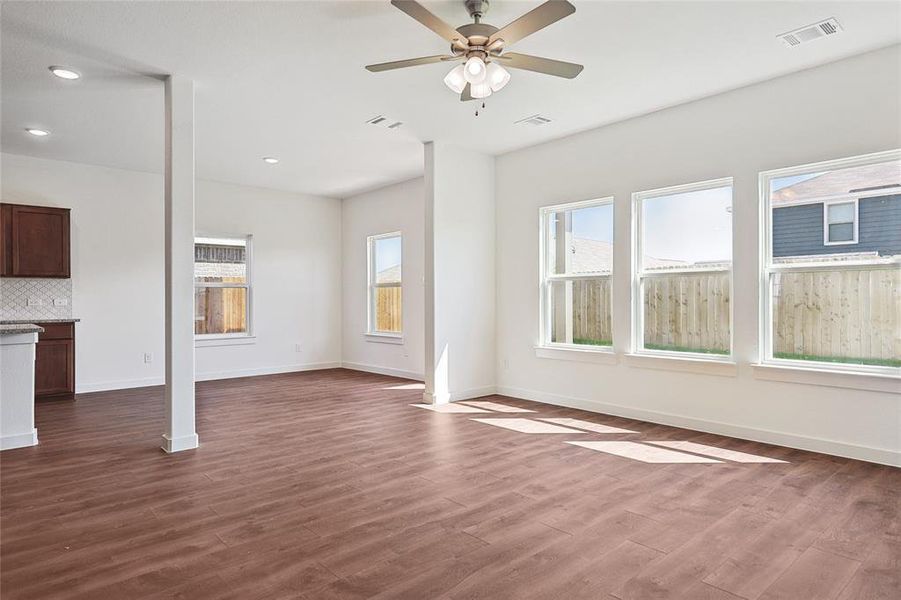 Unfurnished living room with ceiling fan, dark wood-style flooring, and recessed lighting