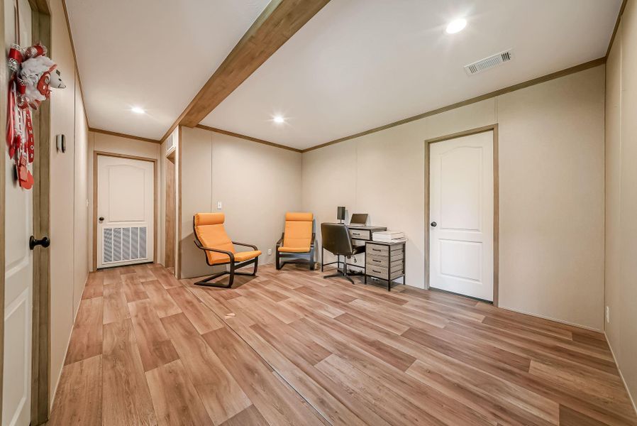 This is a flex space that they use as an office. there are 2 bedrooms on either side and across from this flex space.