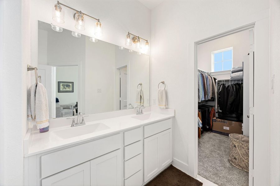 Primary bathroom with dual sinks and modern fixtures