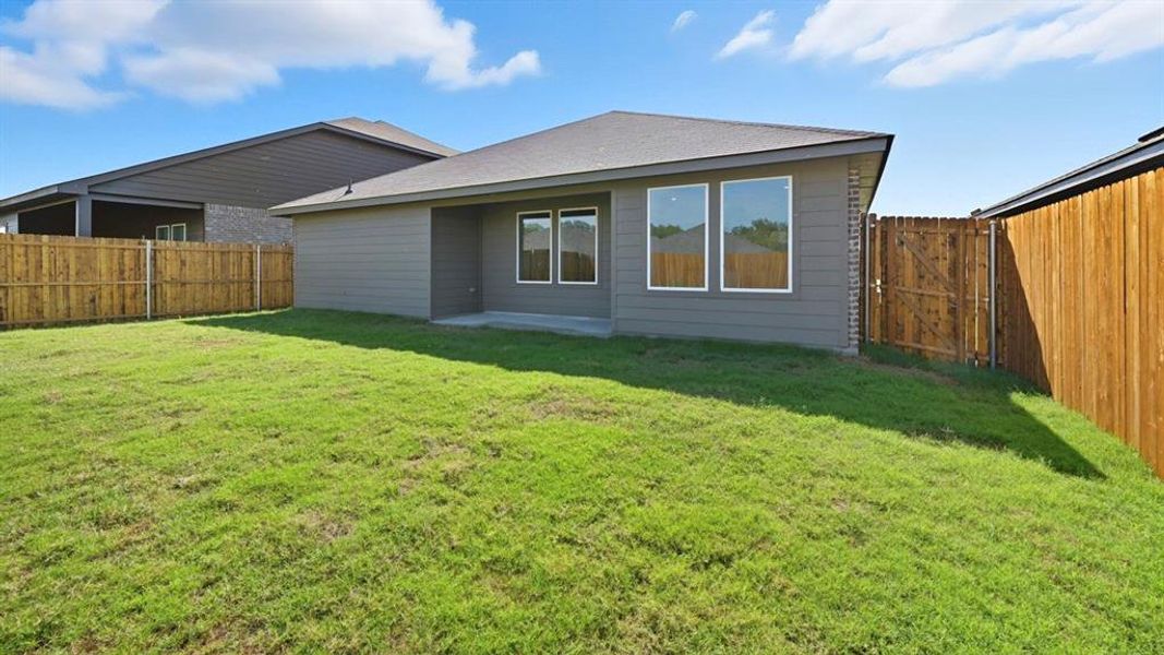 Back of property featuring a patio area, a fenced backyard, a gate, and roof with shingles