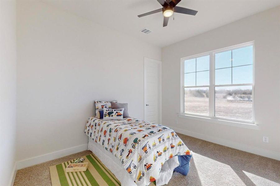 Bedroom with ceiling fan and carpet