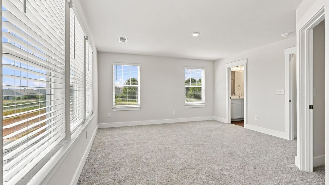 Primary suite that offers first-rate relaxation with established style and elevated finishes by DRB Homes Primary suite that offers first-rate relaxation with established style and elevated finishes by DRB Homes